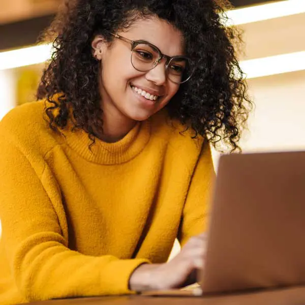 Smiling young woman working at her laptop