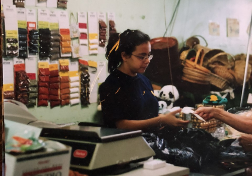 Amanda Saab working the cash register at her family's store, Pesick Brothers.