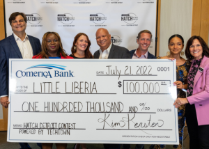 Ameneh Marhaba of Little Liberia standing with representatives from TechTown and Comerica Bank