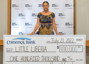 Ameneh Marhaba of Little Liberia standing with $100,000 check