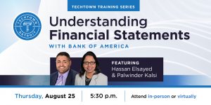 Photo of black male and female holding a workshop on understanding financial statements