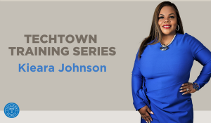Women of color in a blue long sleeve dress representing the TechTown Training Series