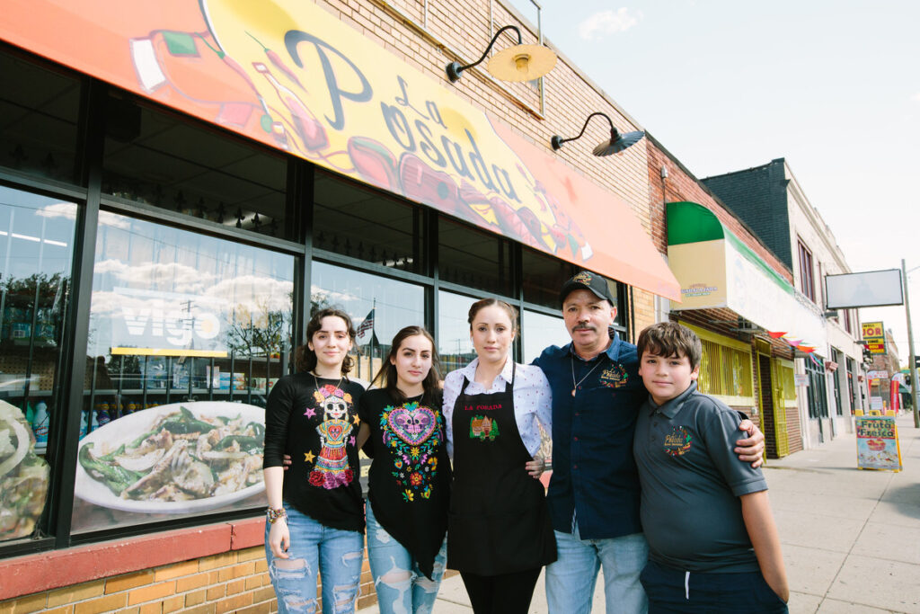 Three women, a man, and a boy, pose outside of their family restaurant, La Posada. 