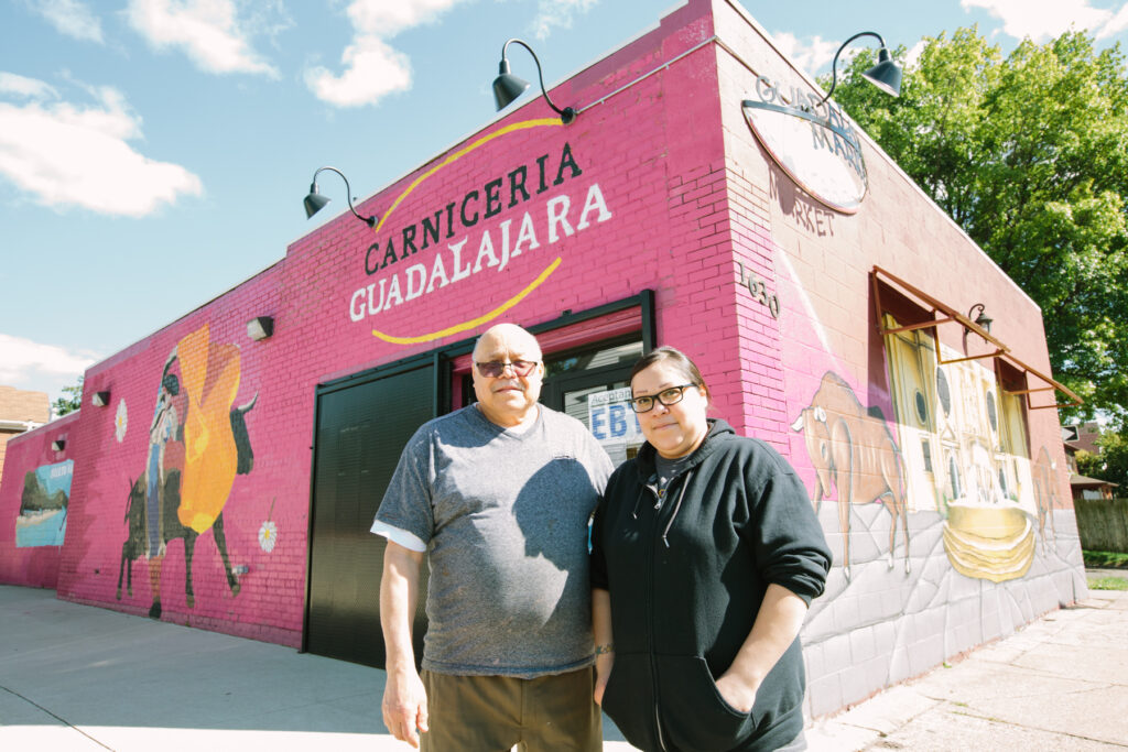 Salvador Enriquez, his daughter, Adriana Hernandez, stand in front of their business