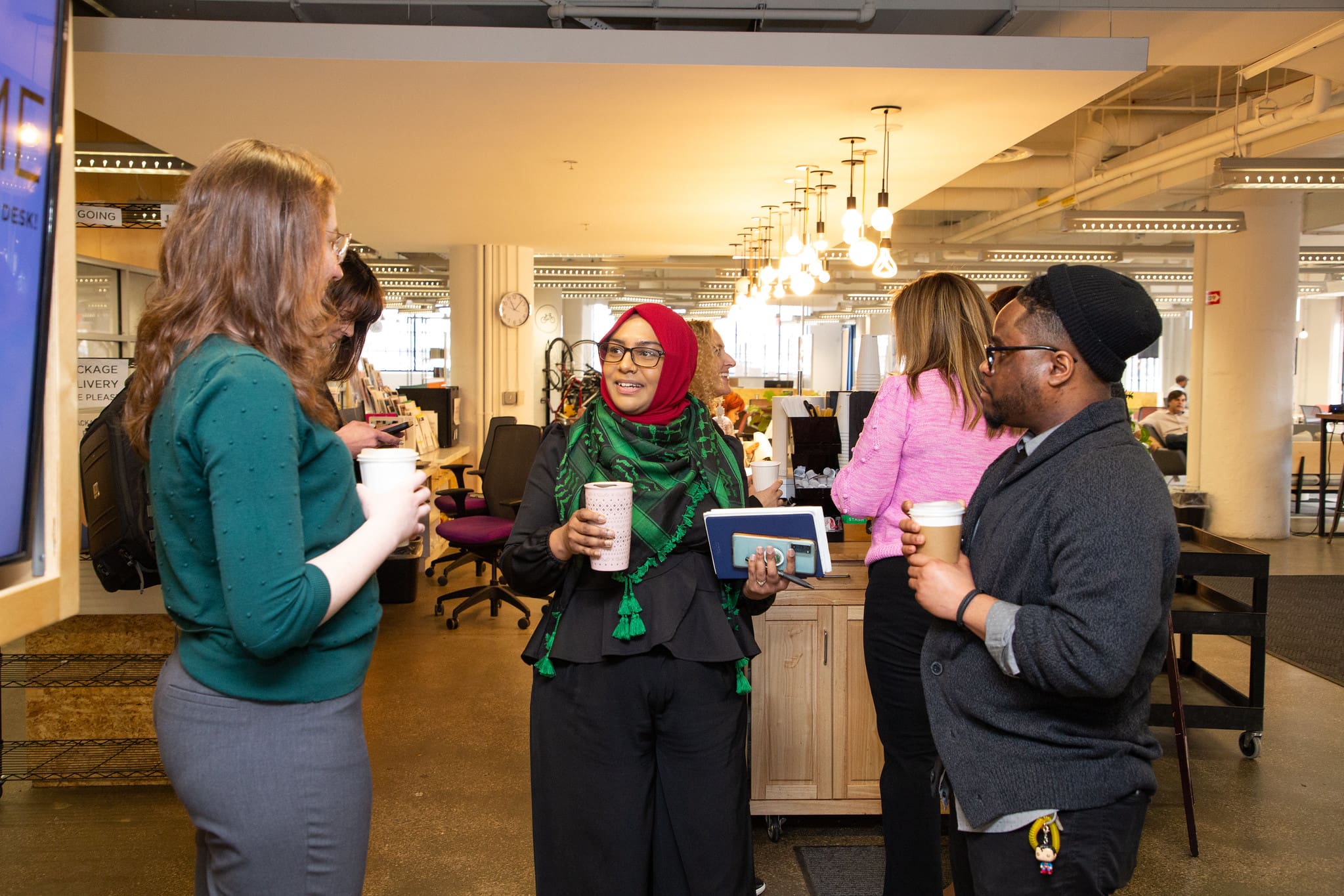 Image of 3 TechTown talking and holding coffee