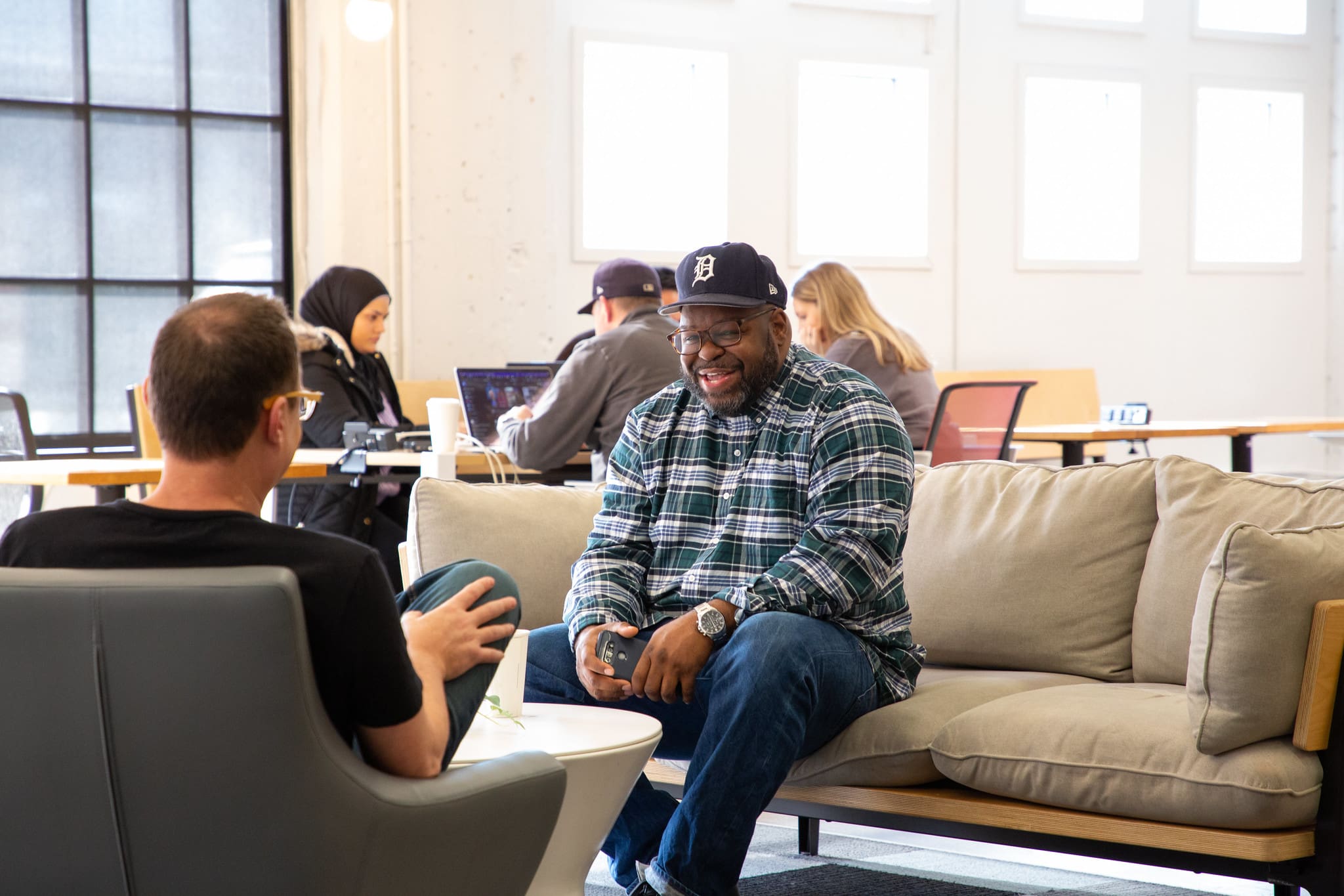 Two people sitting have a conversation