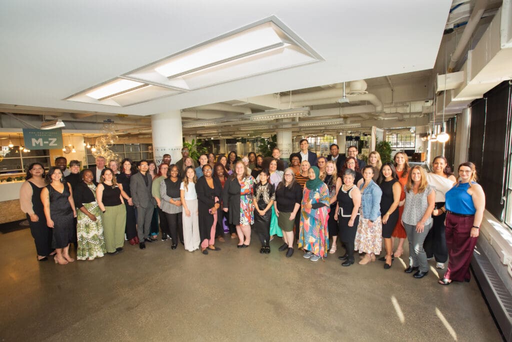 A large group of people smiling for a photo inside TechTown Detroit's coworking facilities