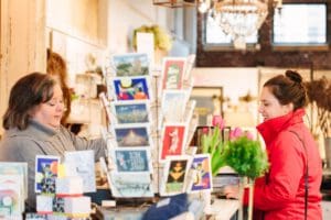 Two women talking with one another in the store during the checkout process