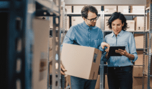 Man asking for direction from women in warehouse regarding exporting international products