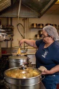 Tamaleria Nuevo Leon owner making tamales in the kitchen