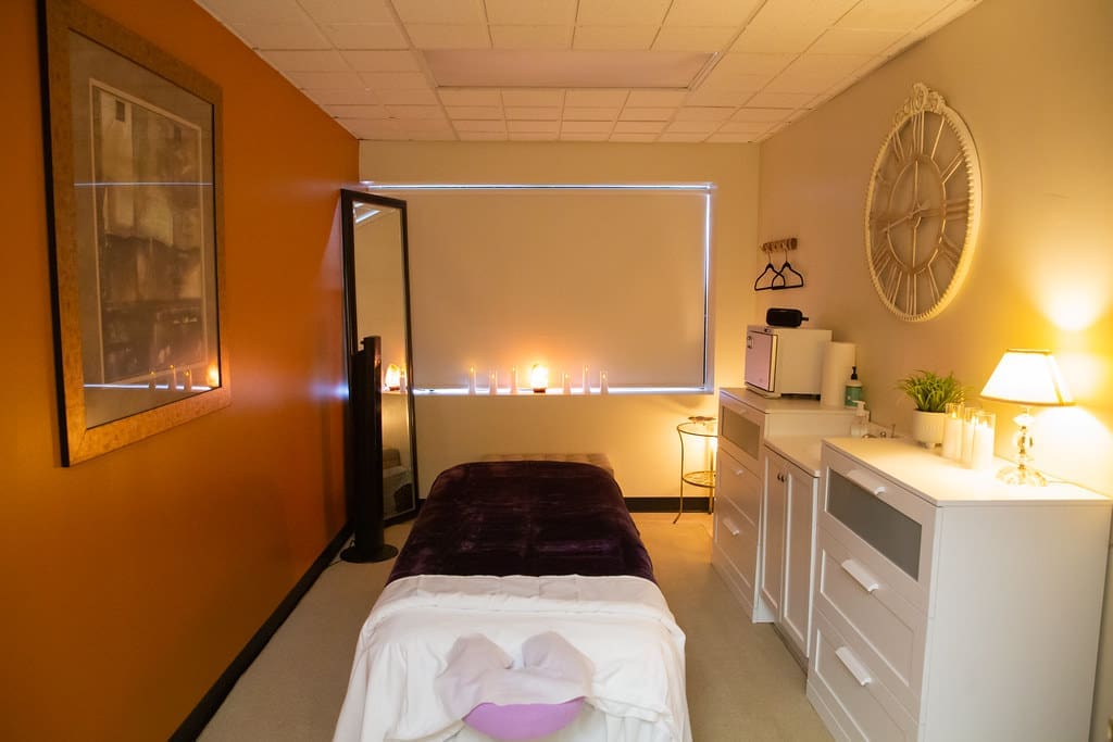 A room with a massage table setup and ambience lighting