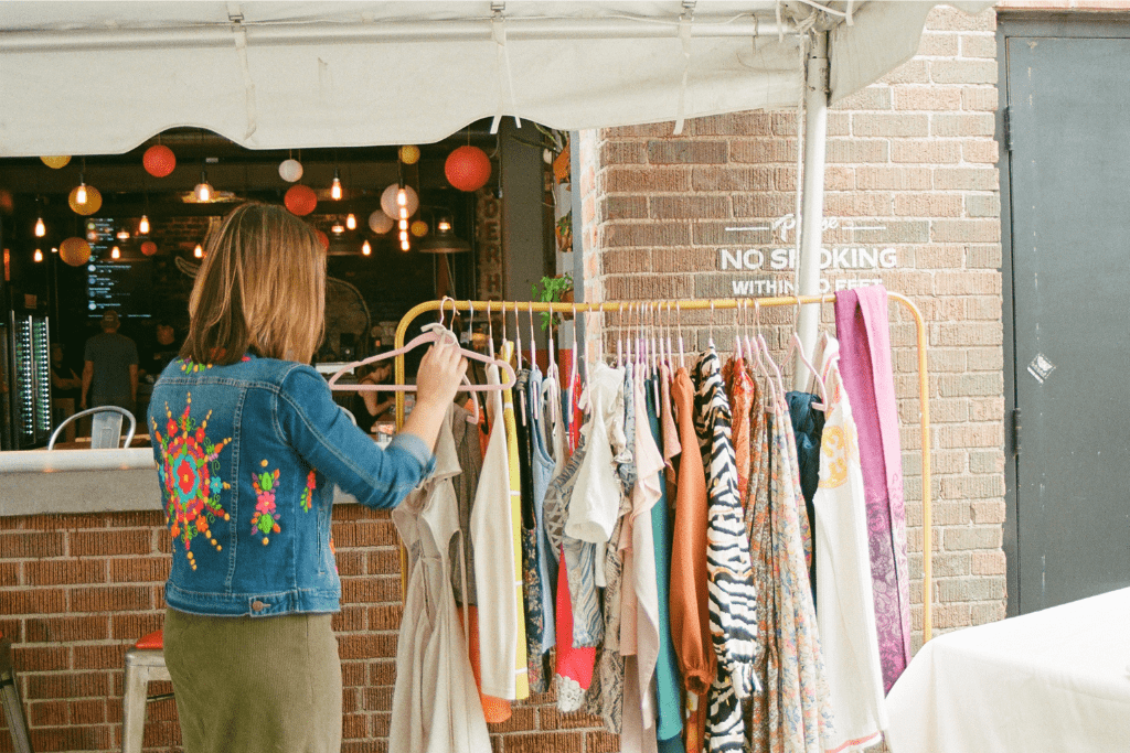 A person looks at a rack of clothing