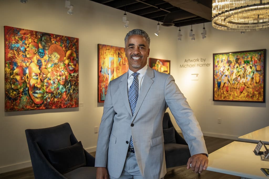 James McKissic, owner of Mac Galleries, smiles for a photo in the gallery and framing shop
