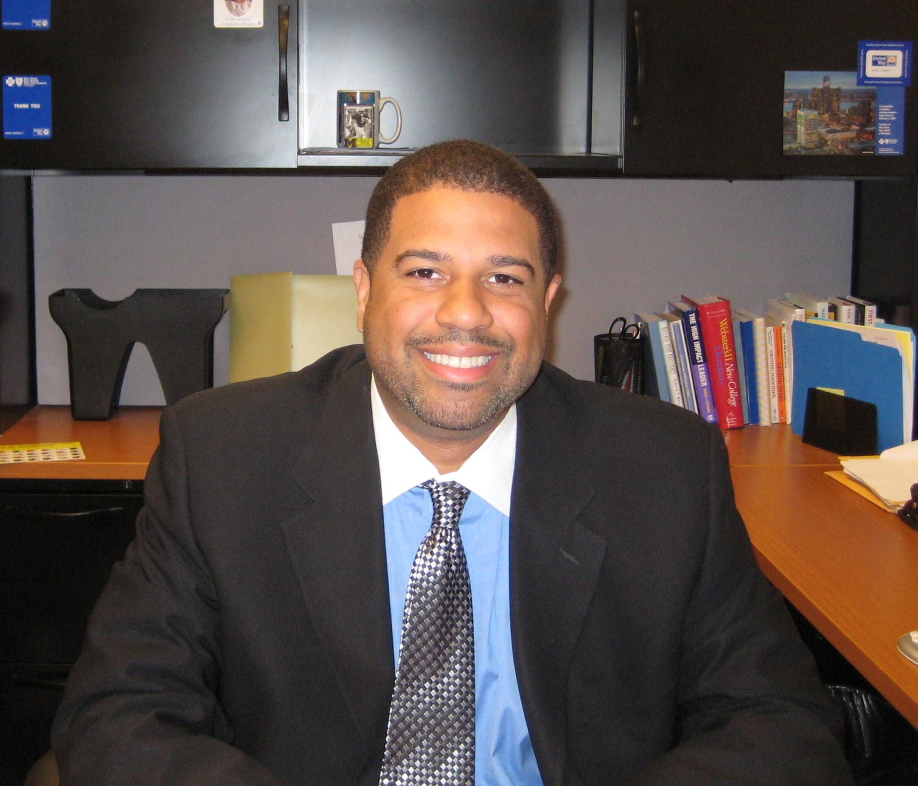 Catalyst Angel Program investor, Keith Jennings wearing a black suit with a grey tie sitting in an office