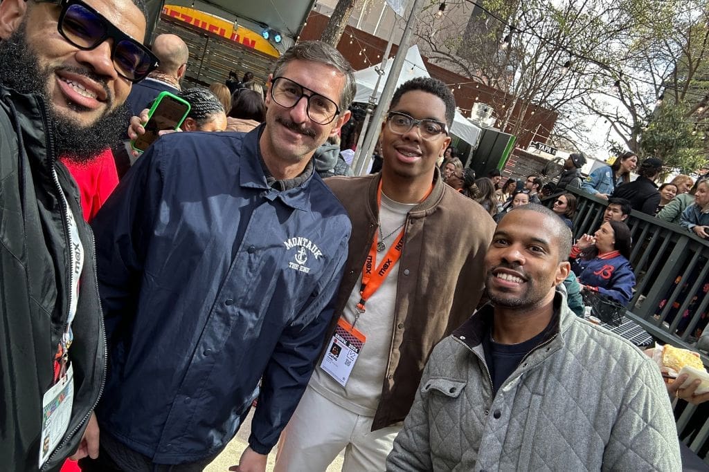 Four people smile and pose for a selfie. The individuals are outdoors at an event for the 2024 South by Southwest conference in Austin, Texas